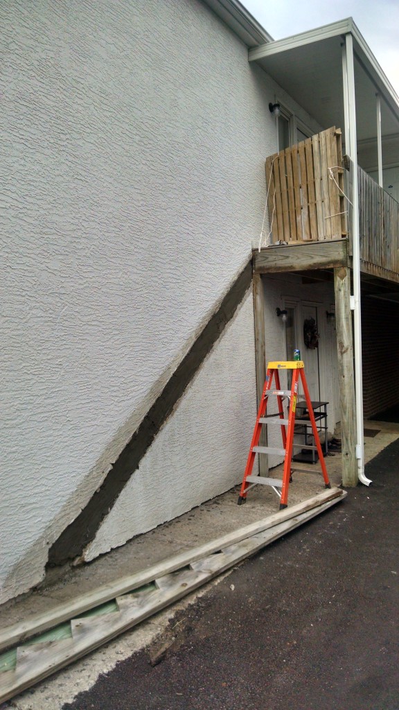 Removed the old steps and patched the side of the building with stucco mortar.